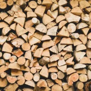 A stack of neatly arranged Firewood pieces displays diverse sizes and shades of brown.