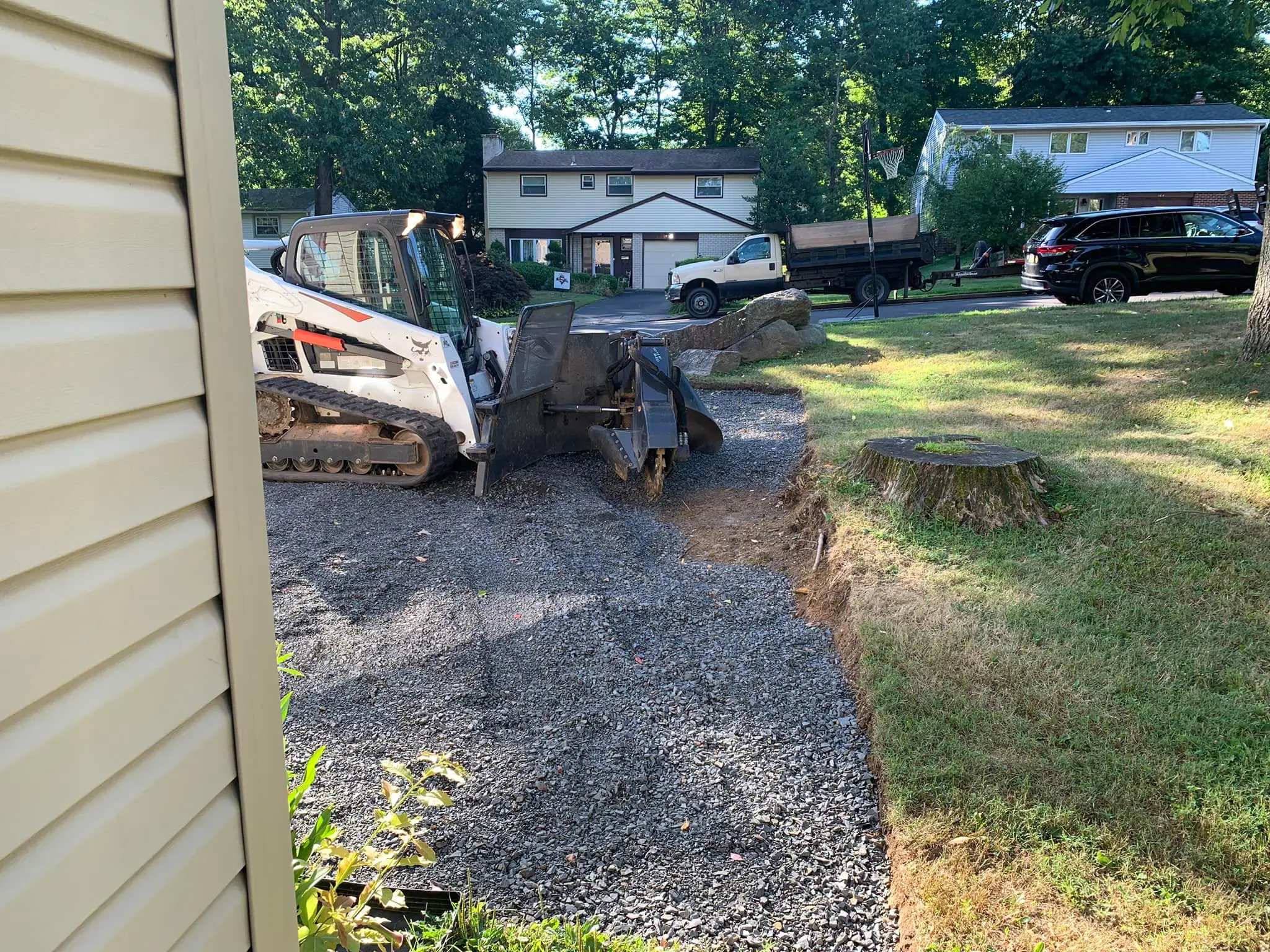 A construction truck parked on top of gravel.