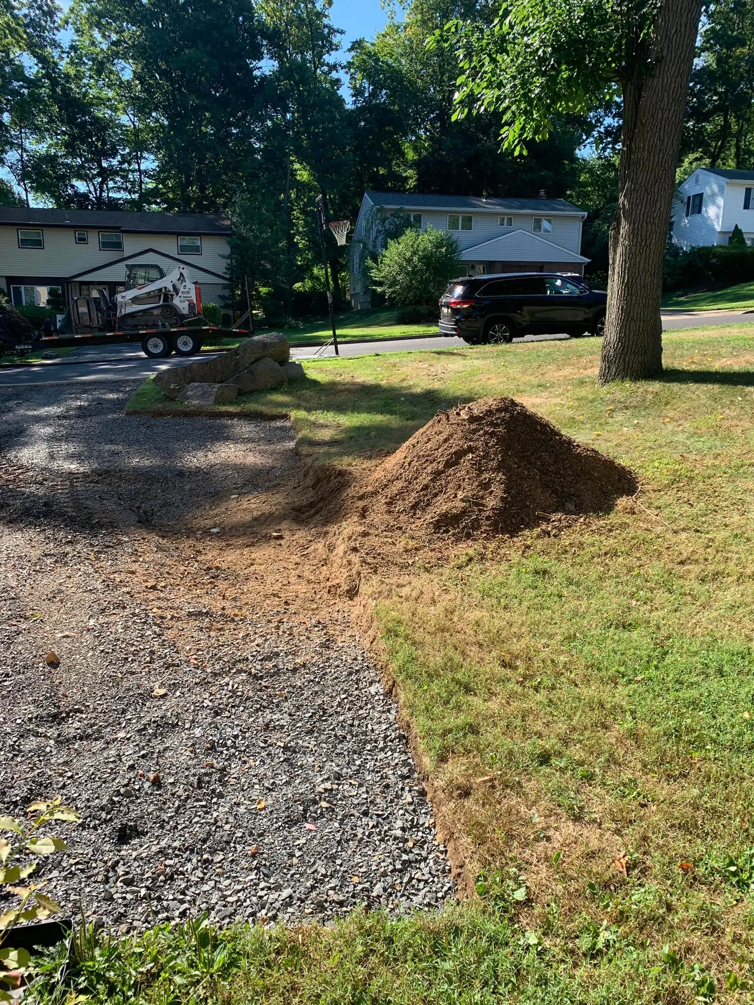 A pile of dirt on the side of a road.