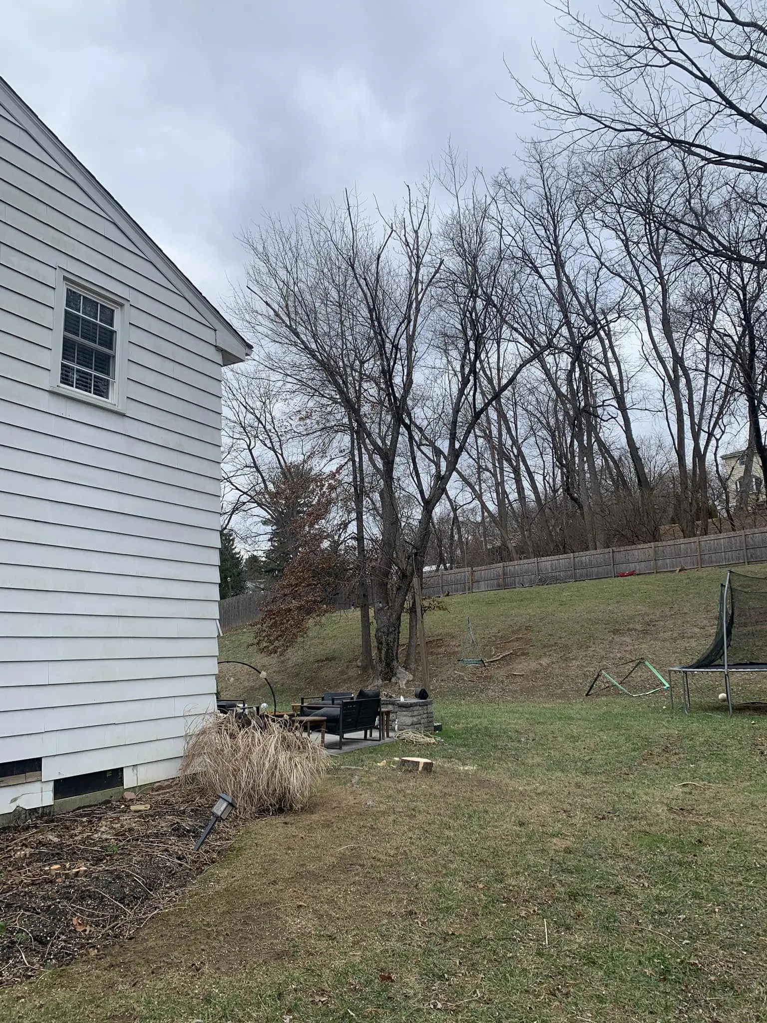 A white house sitting in the middle of a yard.