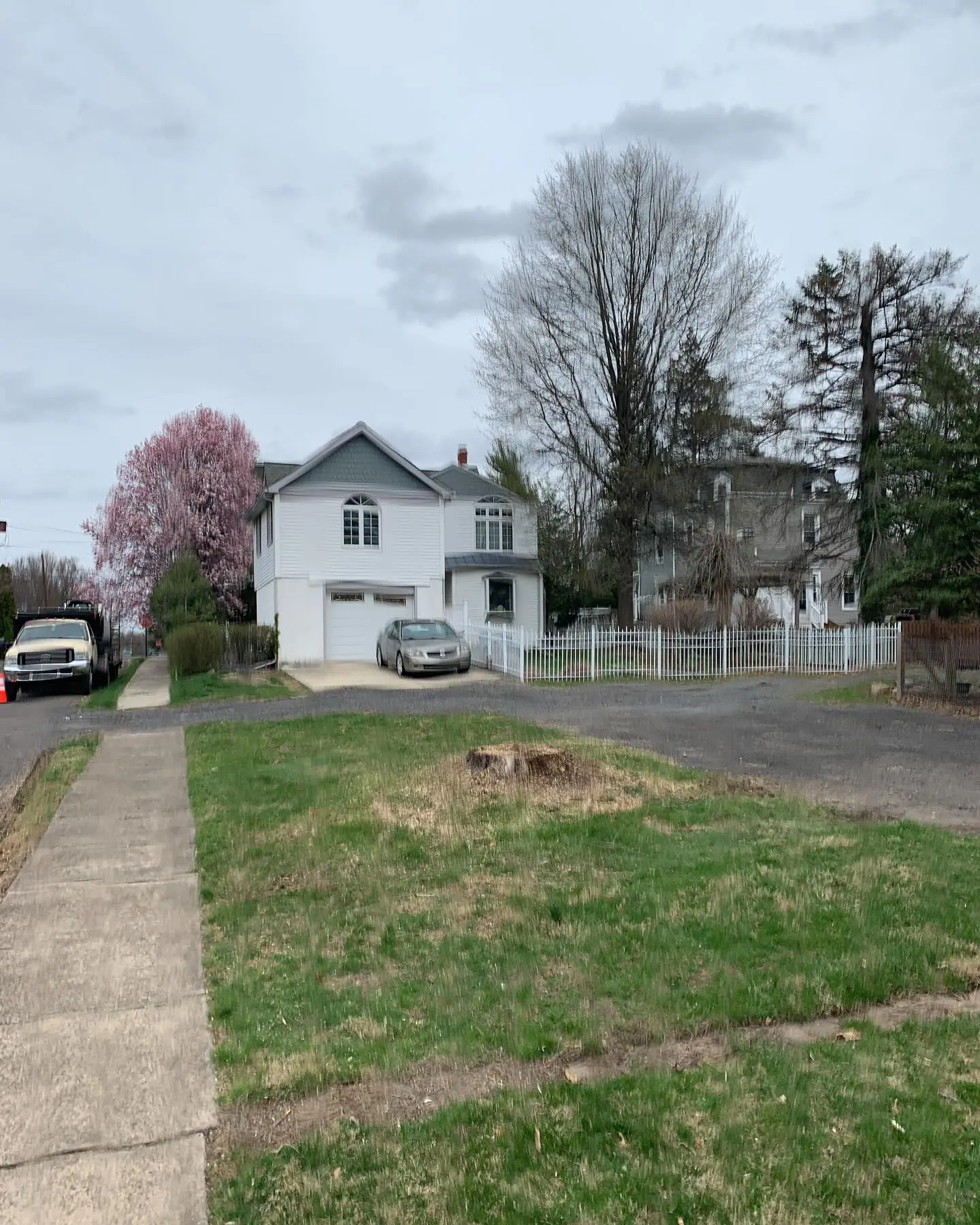 A car parked on the side of a road near a house.